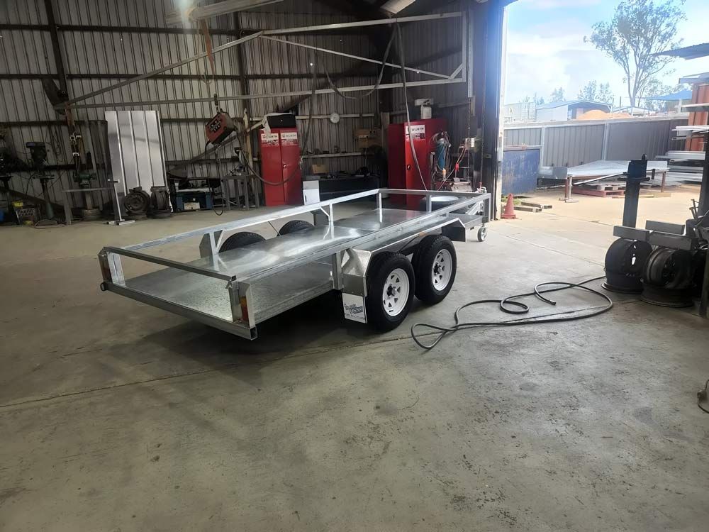 A Trailer Is Parked In A Garage With A Hose Attached To It — Hastings Trailer Centre in Port Macquarie, NSW
