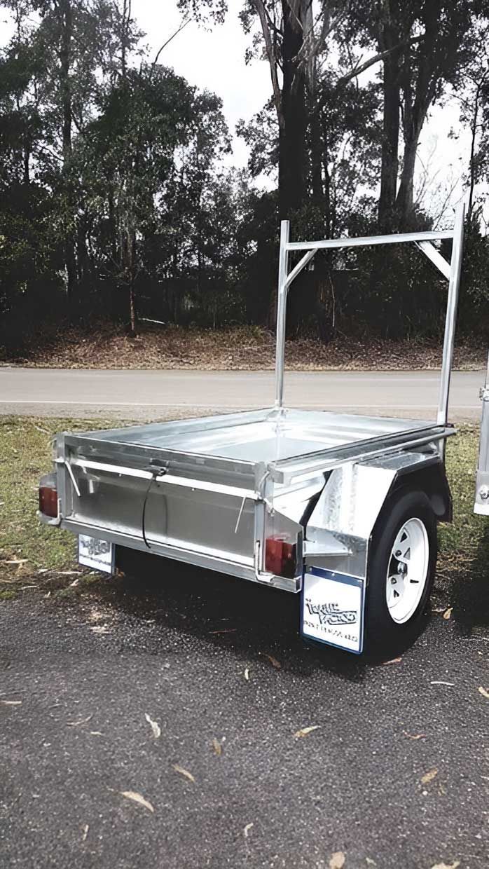 A Two Wheeler Trailer Is Parked In A Grassy Area Road — Hastings Trailer Centre in Port Macquarie, NSW