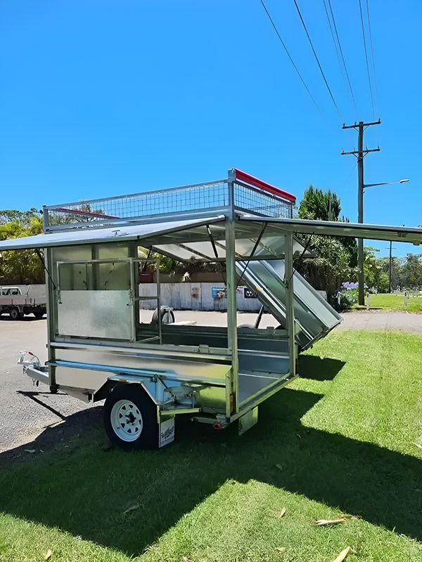 A trailer is parked on the grass in a parking lot Hastings Trailer Centre in Port Macquarie, NSW