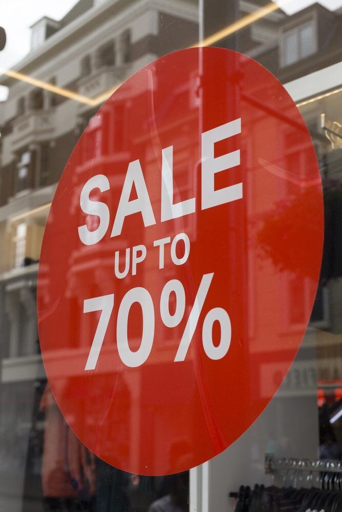 A Red Sign in a Store Window Says Sale Up to 70 % — Caledonian Colour In Kunda Park, QLD