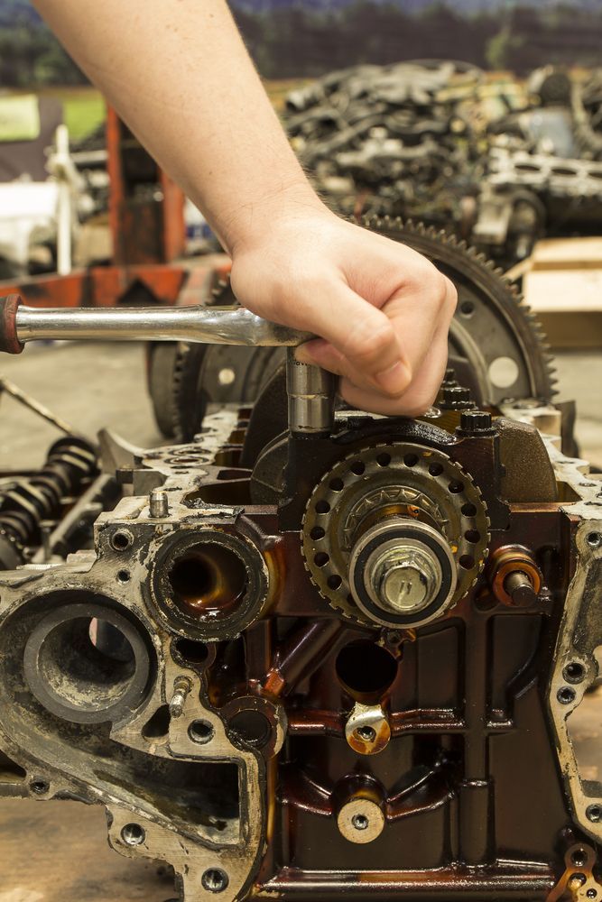 Hand Using a Wrench to Work on a Car Engine — Jims Auto Care in Berrimah, NT