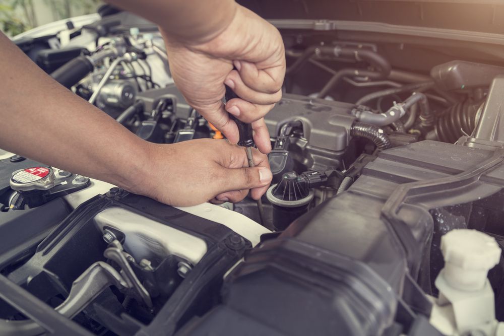 Hands Working on a Car Engine — Jims Auto Care in Berrimah, NT