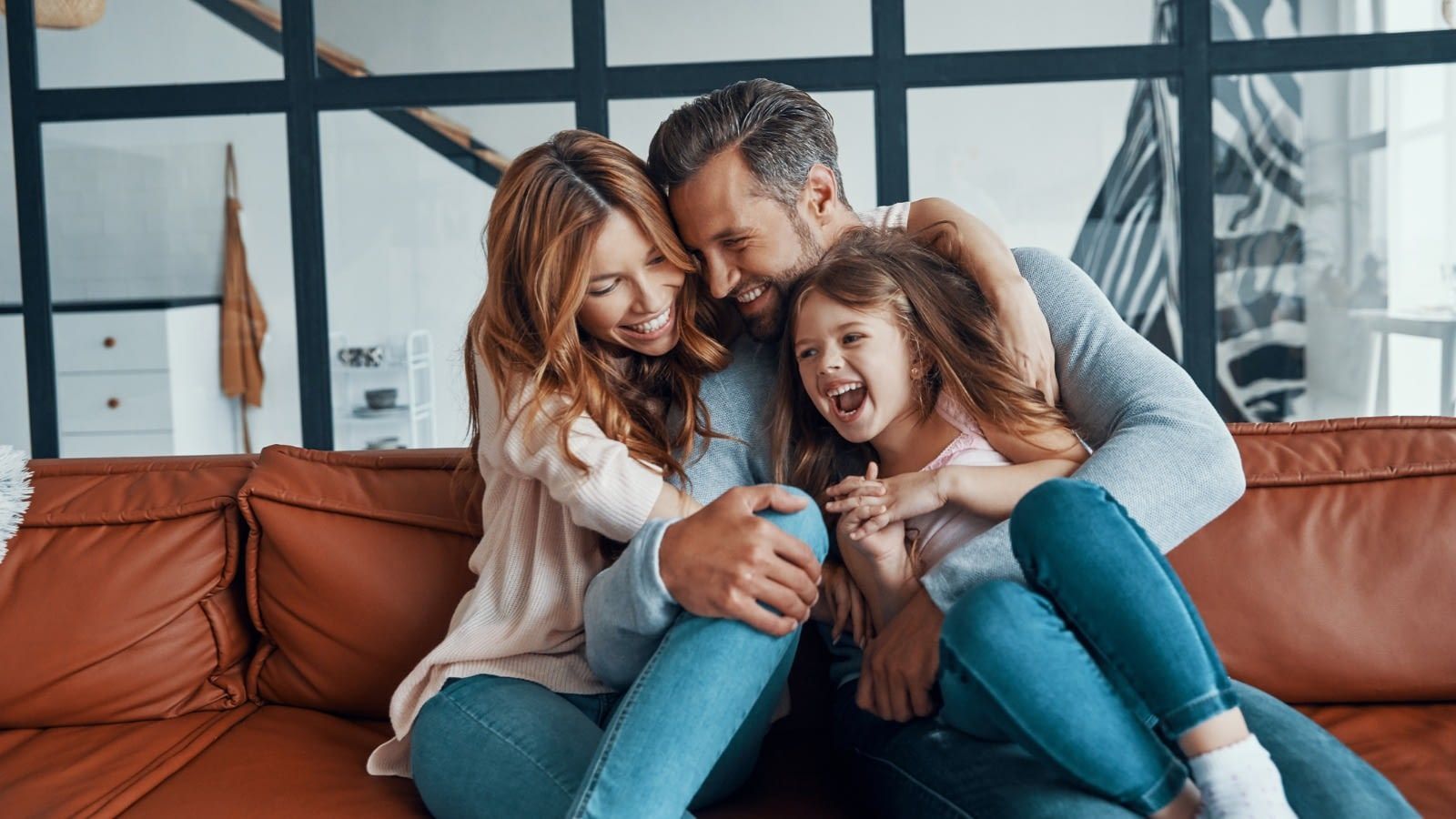 Young couple happy on the couch Happy family sitting together
