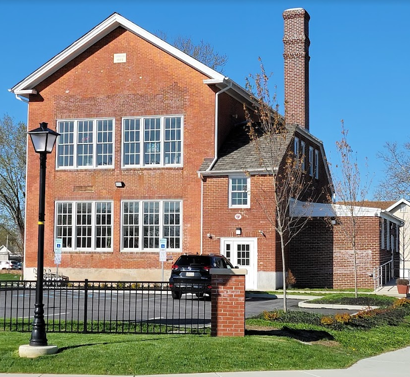A brick building with a car parked in front of it