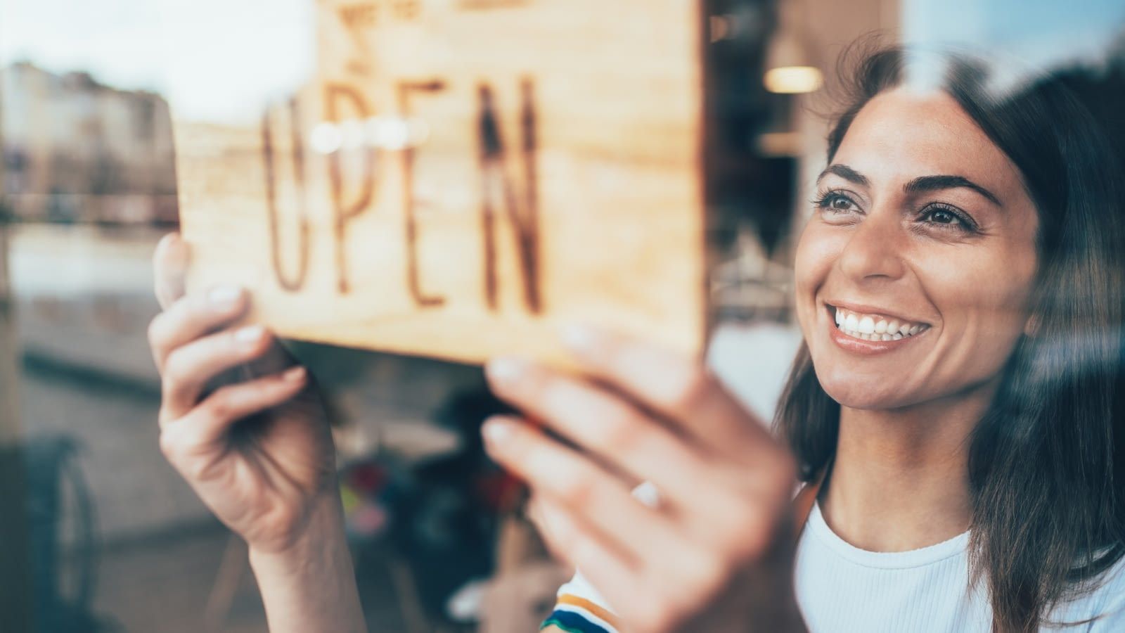 starting a business businesswoman turning window sign to open