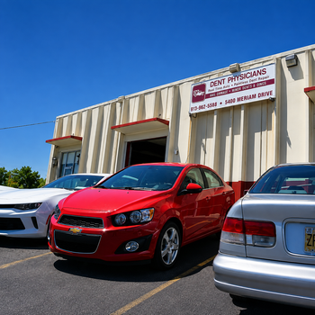 Red sedan parked outside a white building under a clear blue sky