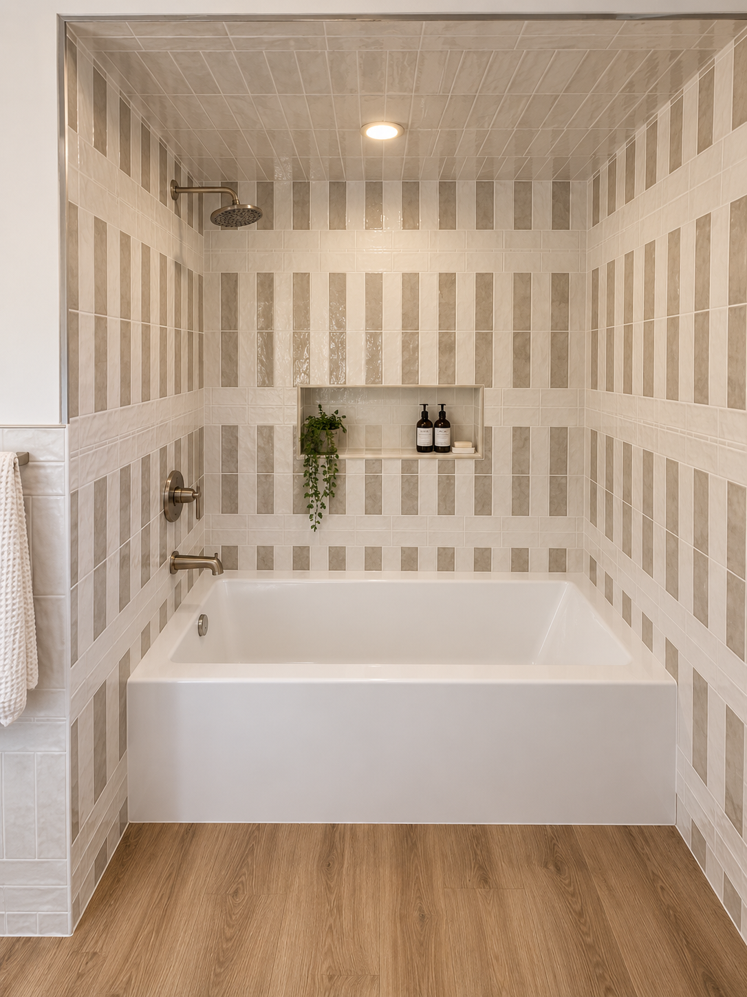 Modern bathroom with a white freestanding tub, striped tile walls, and wood-look floor