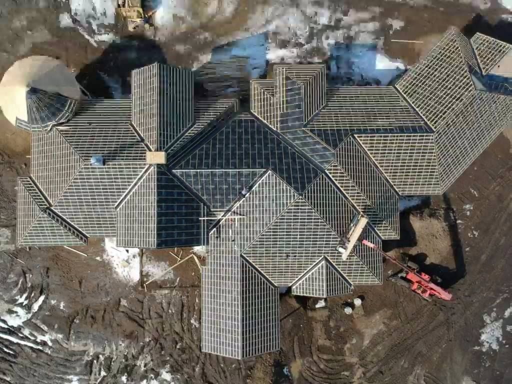 An aerial view of a large house under construction.