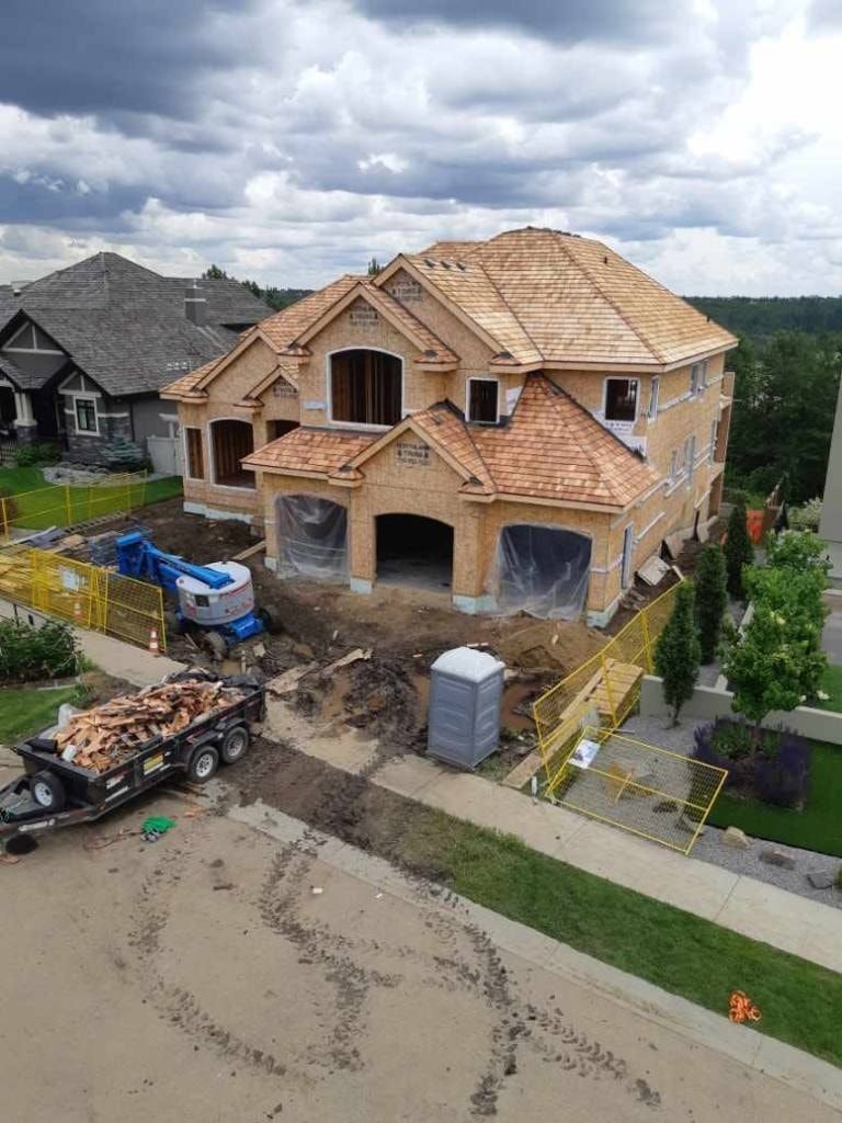An aerial view of a house under construction in a residential area.