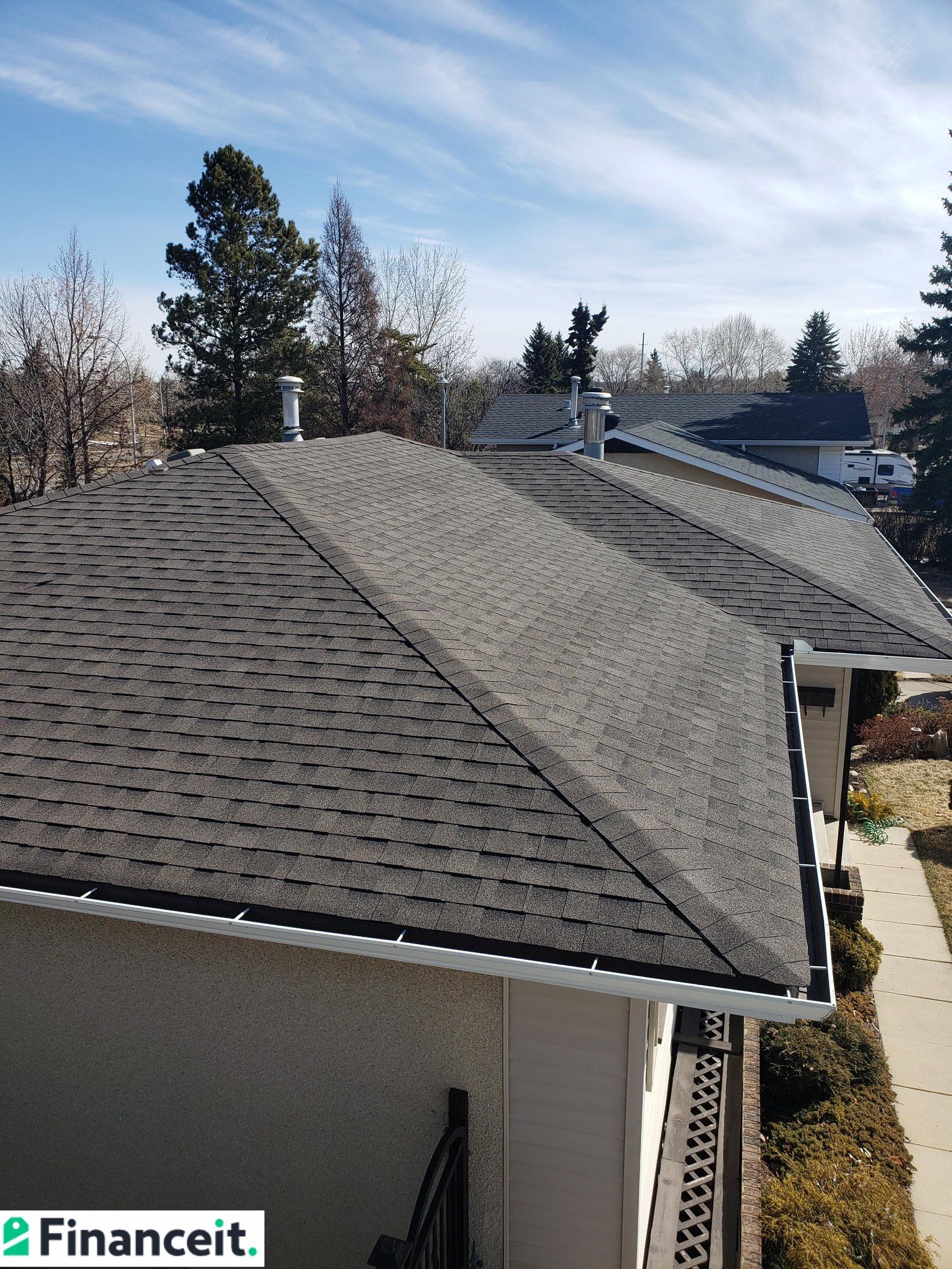 A house with a roof that is covered in shingles.