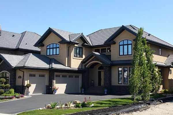 A large house with a lot of windows and a driveway