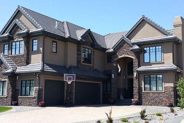 A large house with a basketball hoop in front of it