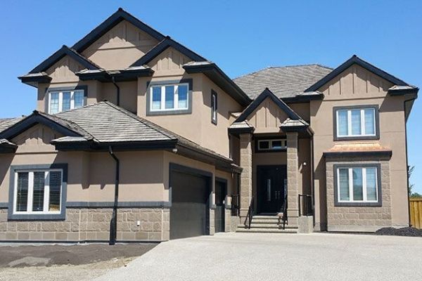 A large house with a lot of windows and a garage