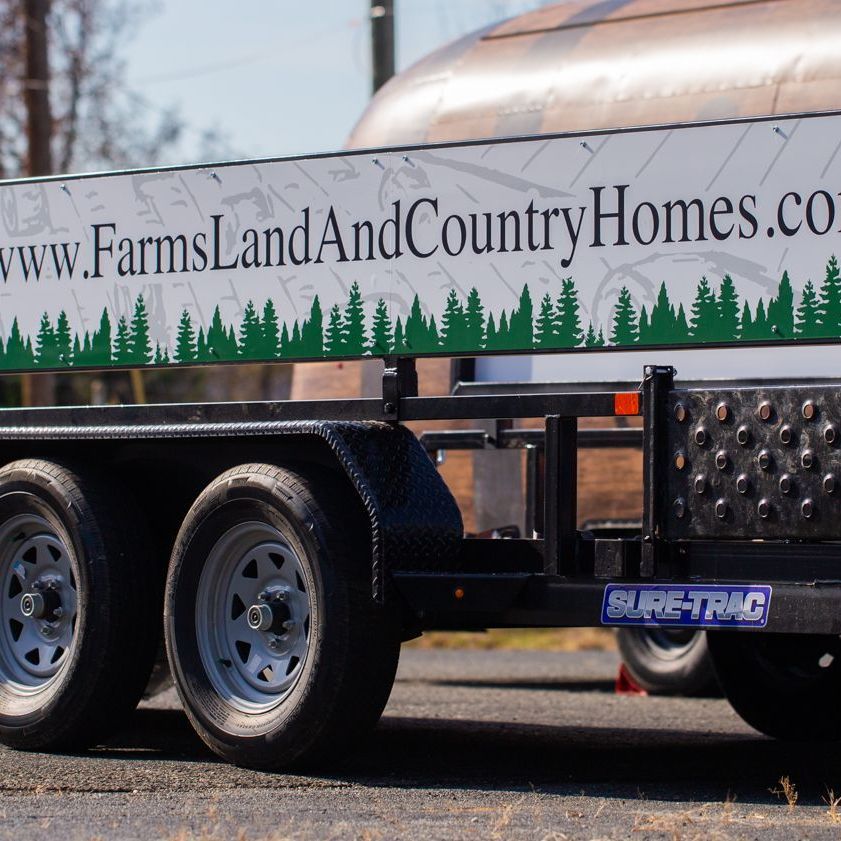 Sign attached to trailer for real estate business