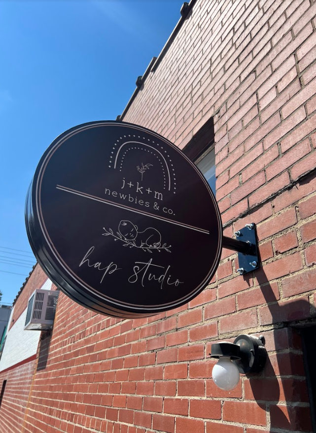 Custom fabricated, circular signage standing off of the wall