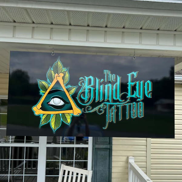 Sign for tattoo shop suspended from ceiling