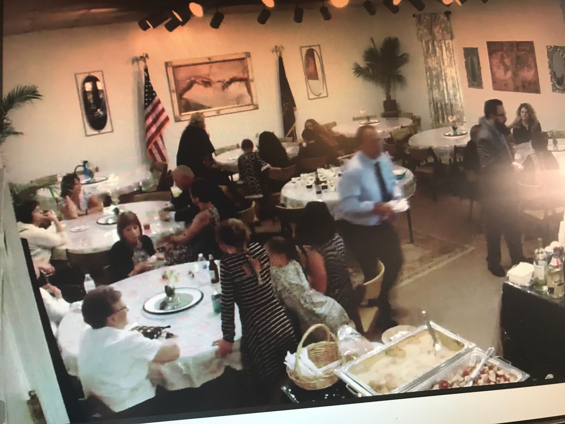 A group of people are sitting at tables in a restaurant