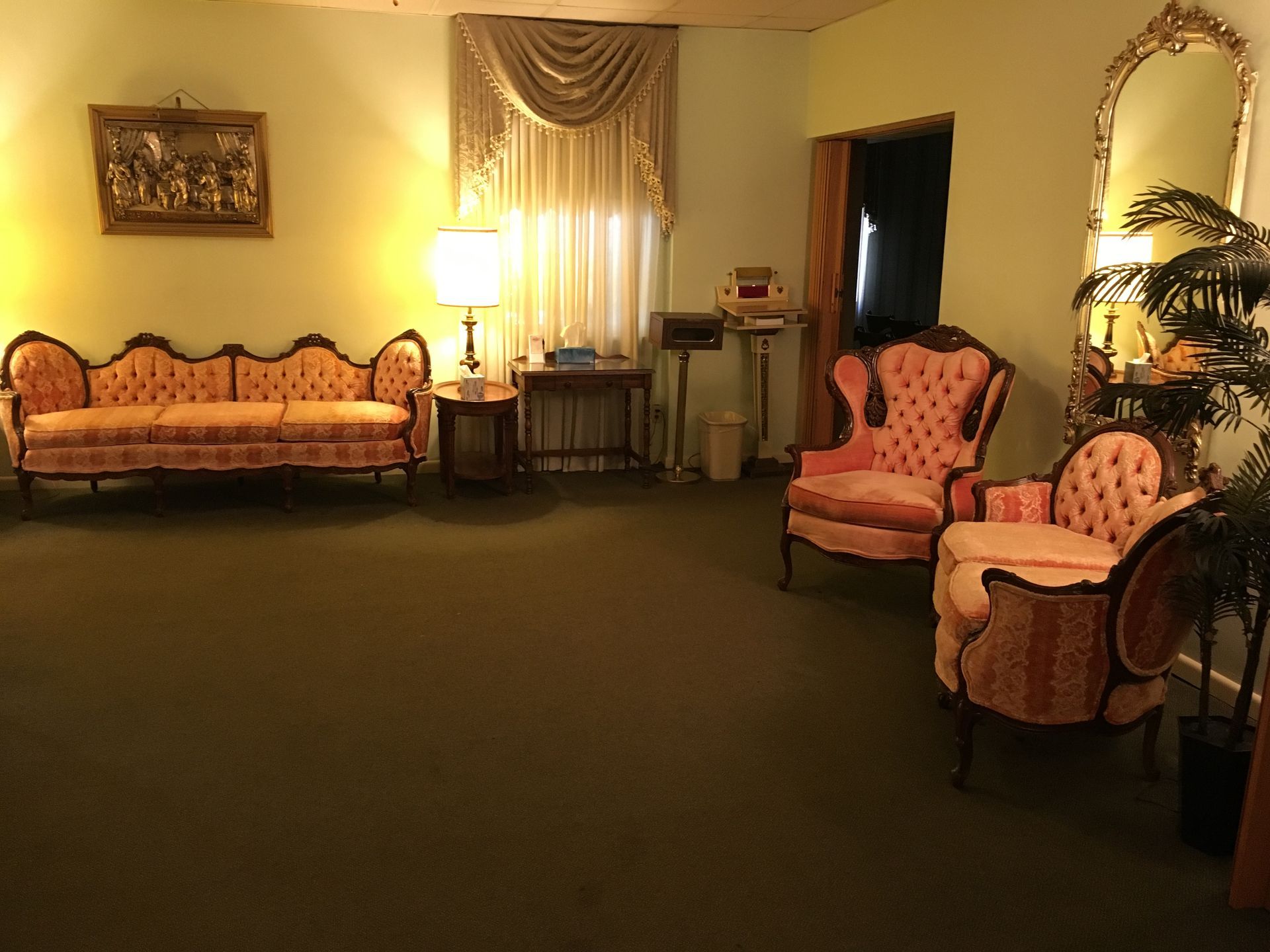 A living room with a couch and two chairs