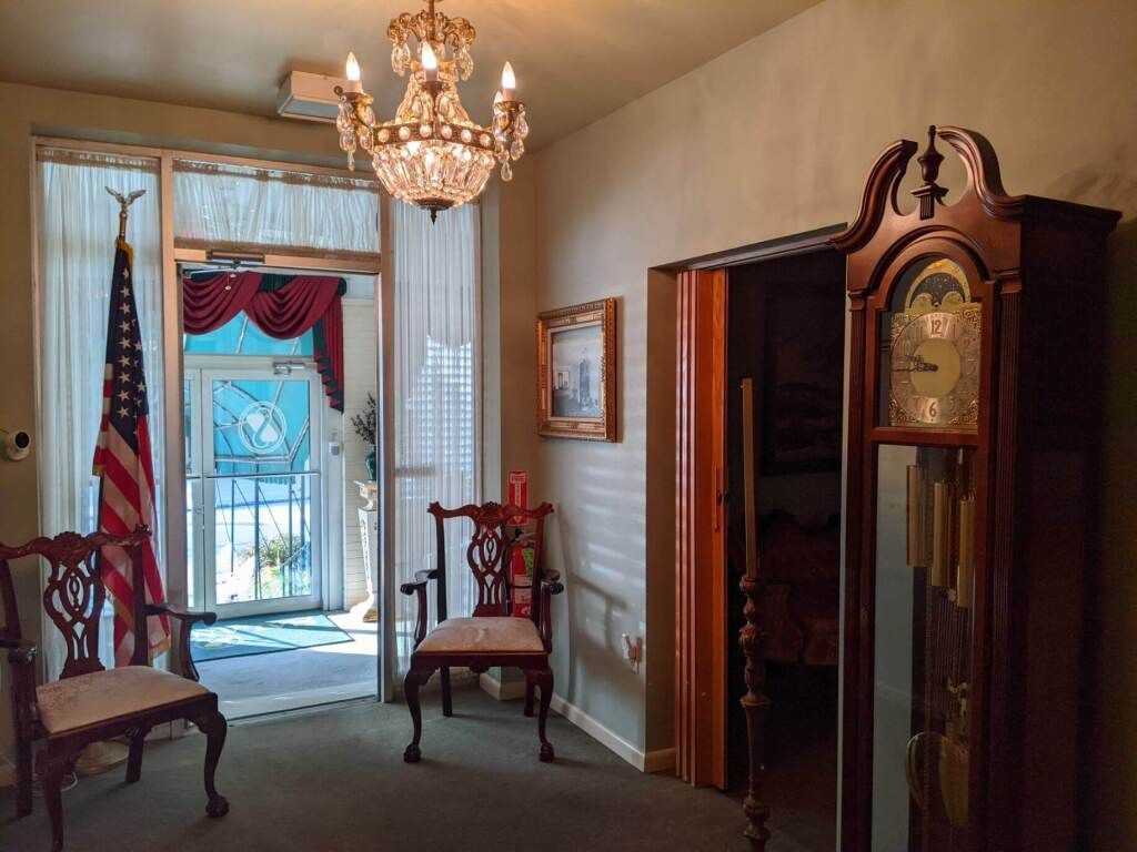 there is a large grandfather clock in the middle of the room .