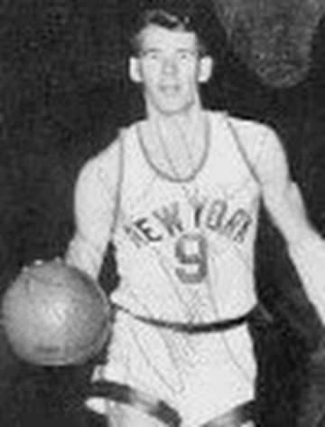A man in a new york jersey is holding a basketball.