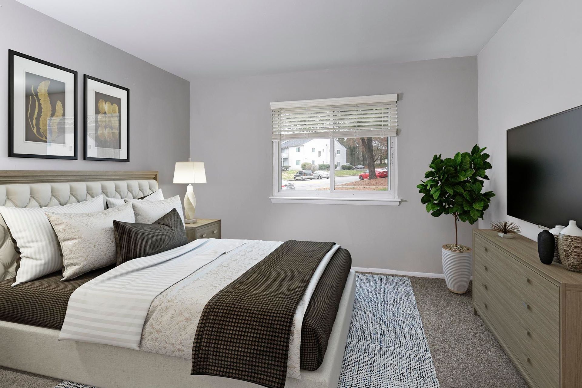 Bedroom with bed, dresser, TV, and window; neutral colors.