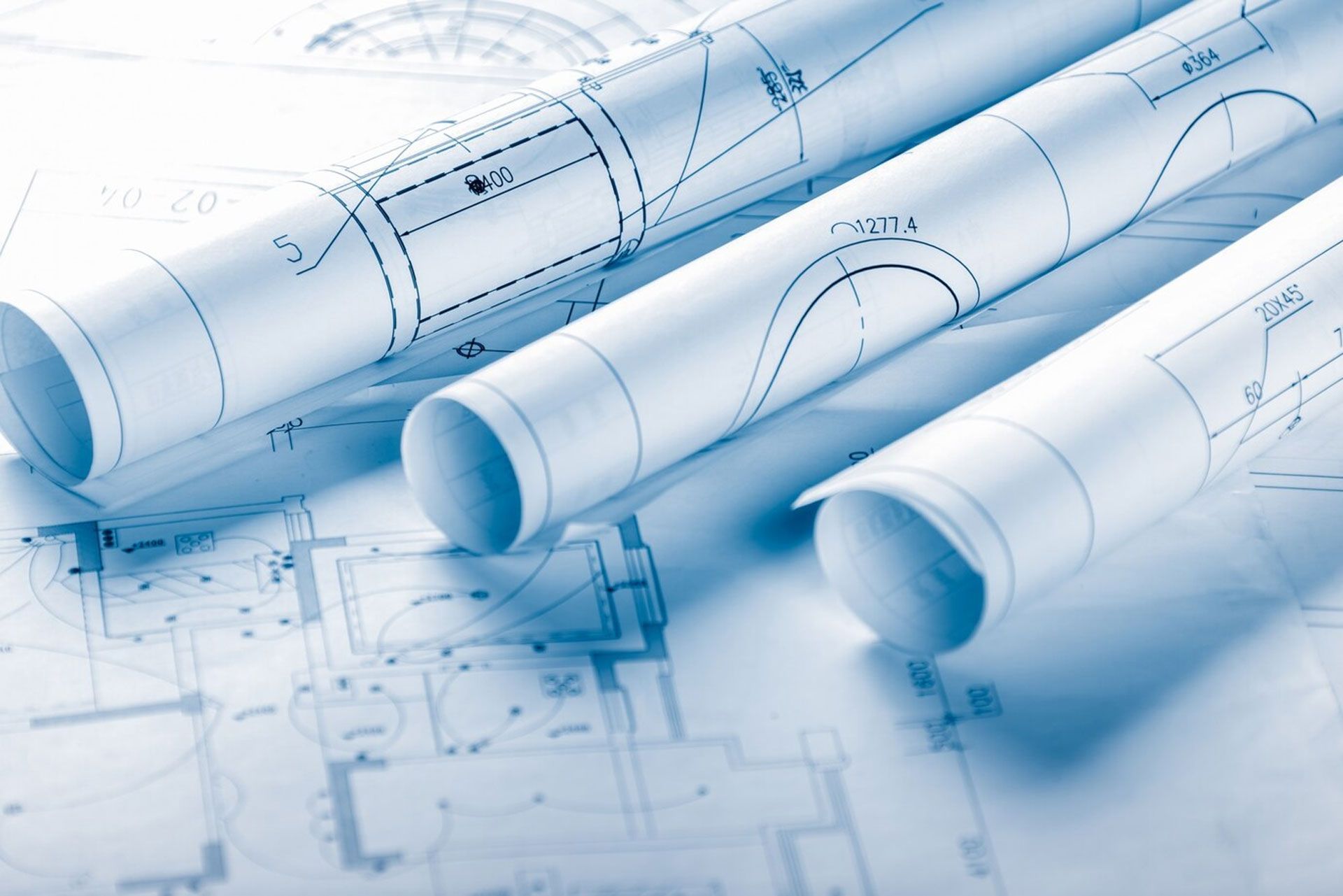 several rolls of blueprints are laying on a table