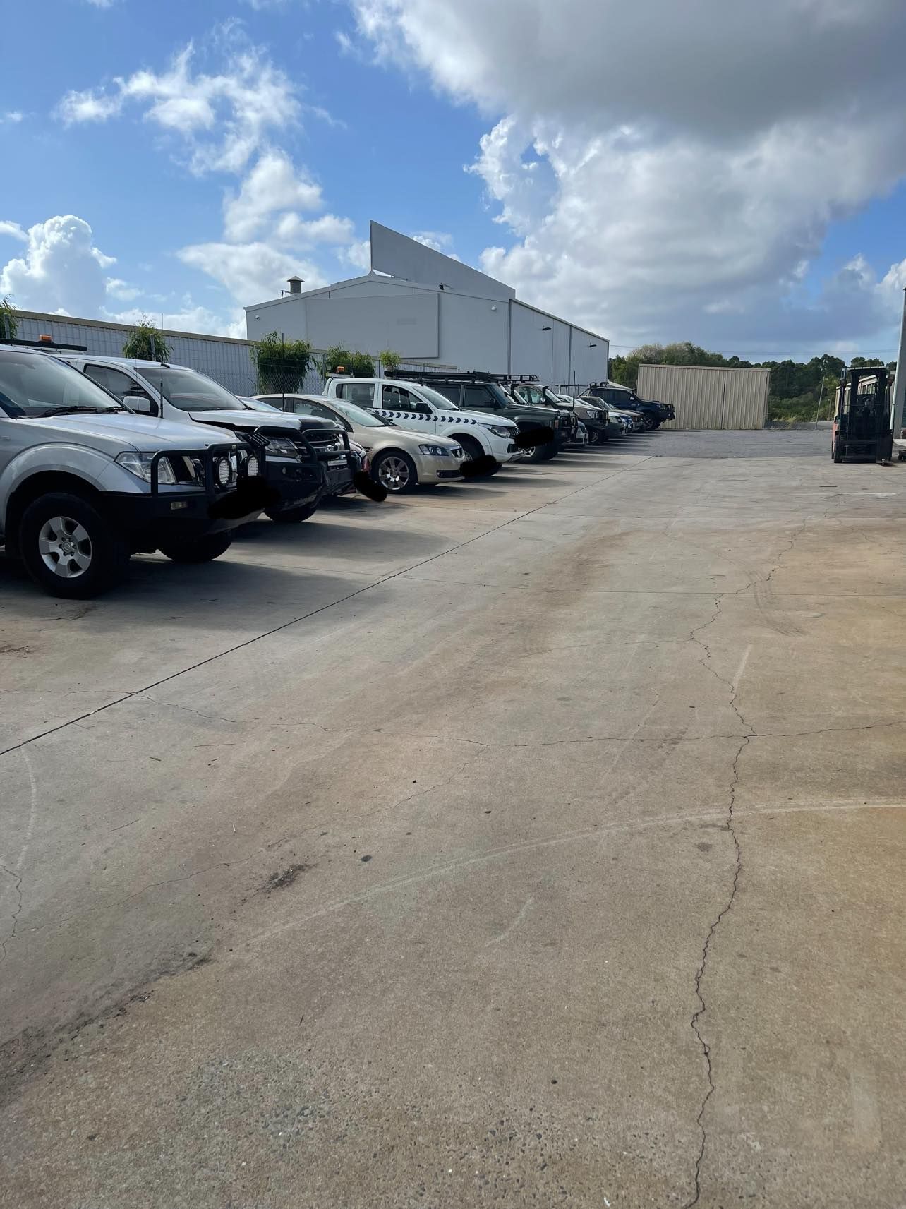 Line of Damaged Tesla Cars Parked in Front of a Building — Gladstone Fleet Maintenance In Gladstone, QLD
