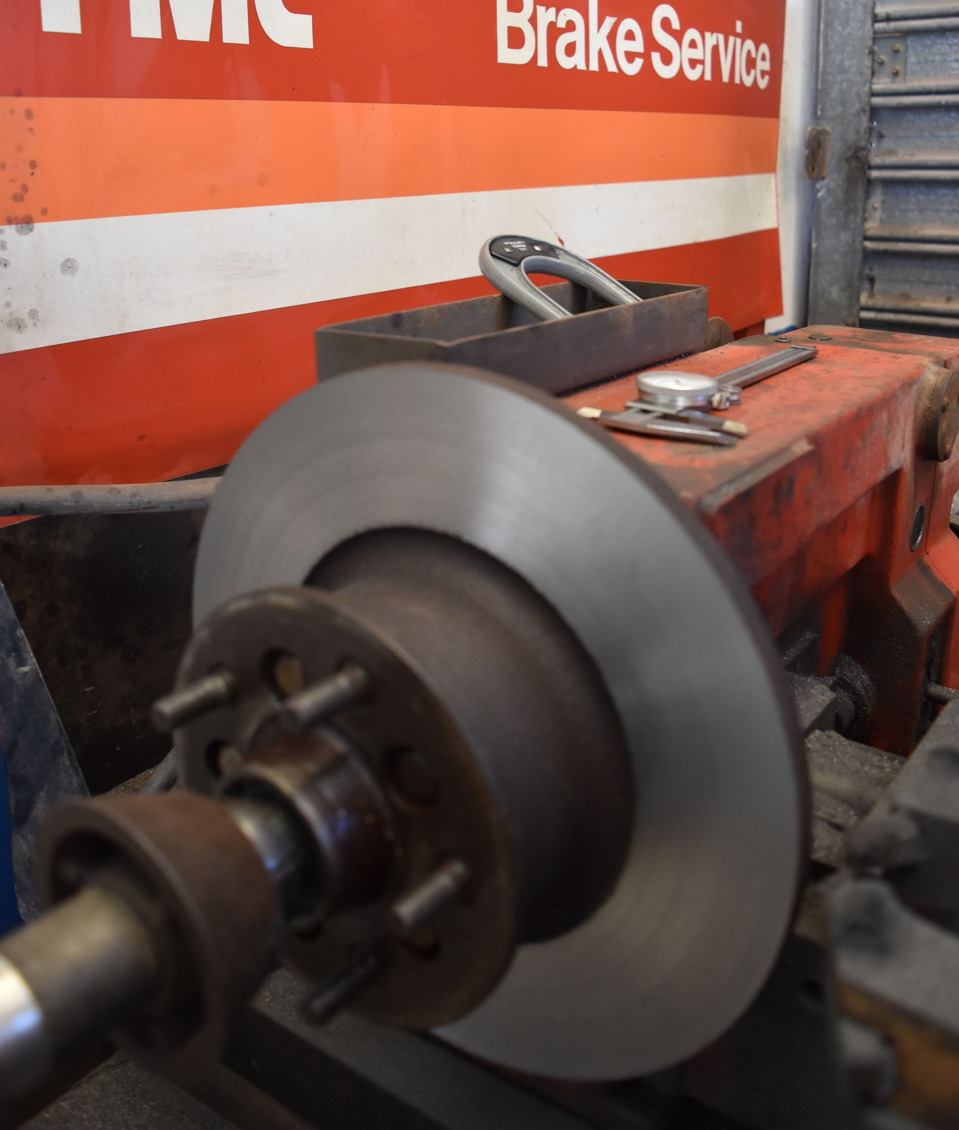 Hands in Black Gloves Holding a Damaged Clutch Disc During Repair — Gladstone Fleet Maintenance In Gladstone, QLD