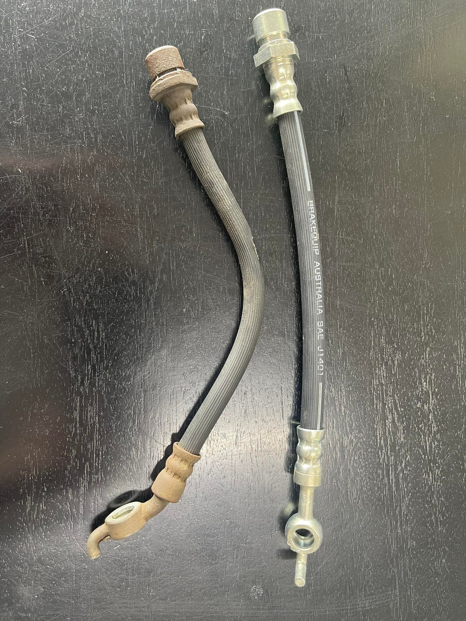 Two Brake Hoses, Old and New, on a Dark Surface — Gladstone Fleet Maintenance In Gladstone, QLD