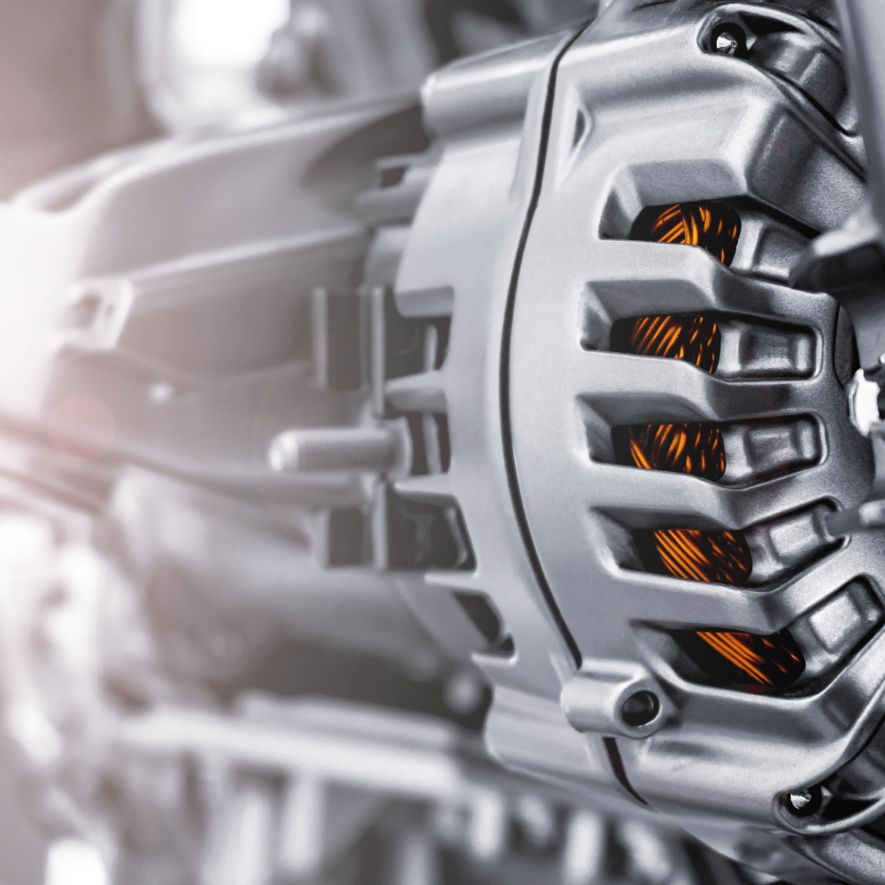 A close up of an alternator on a car engine.