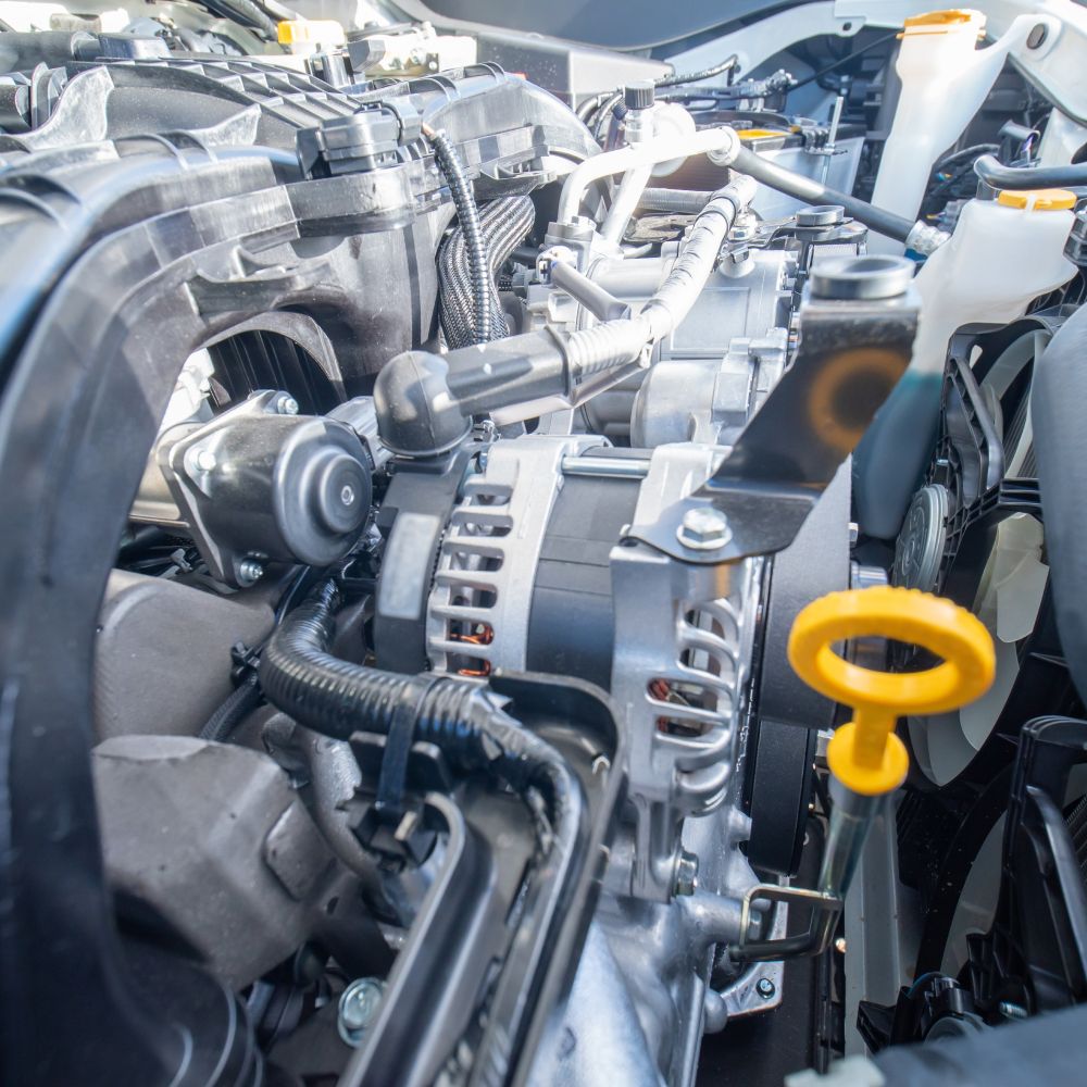 A close up of a car engine with the hood open