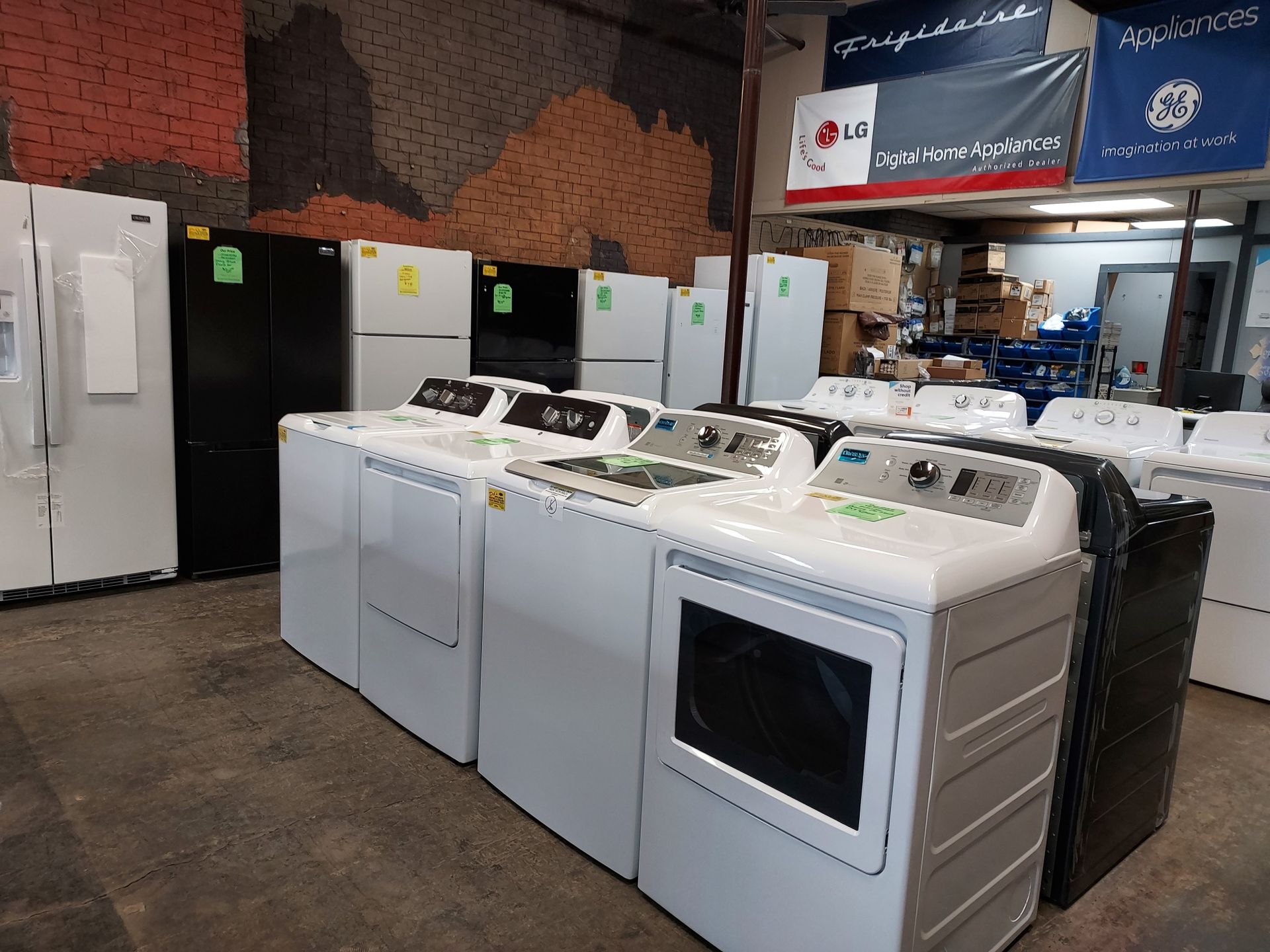 A warehouse filled with a variety of appliances including a washer and dryer.