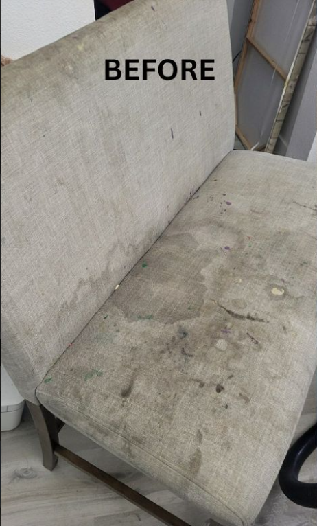 Carpeted staircase with dark stains on several steps, viewed from below.