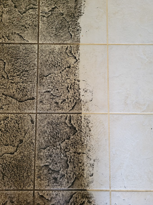 Split view of rough gray stucco and smooth white tiled wall separated by a jagged edge