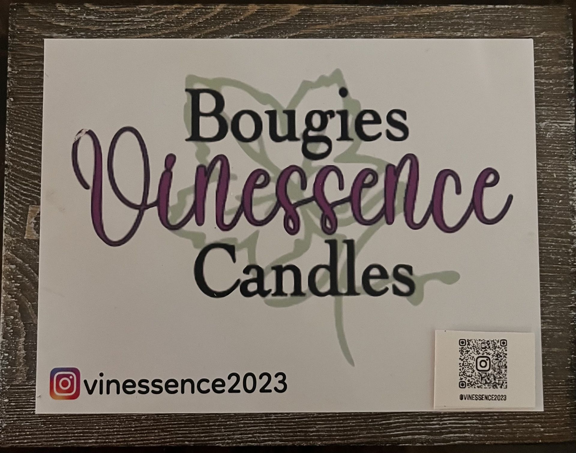 Bougies Vinessence Candles logo on a white sign with purple and black lettering and an Instagram handle.