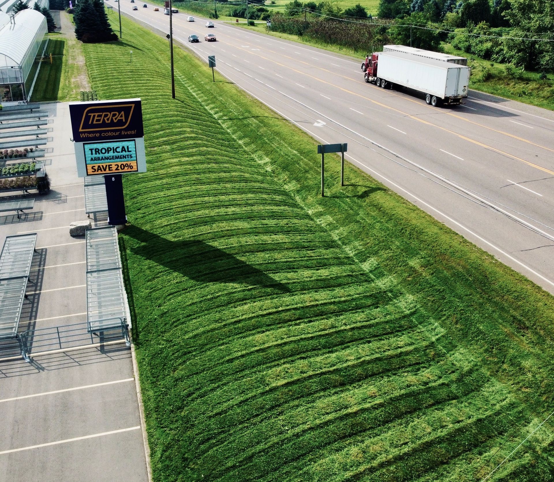 A truck is driving down a highway next to a tetona sign
