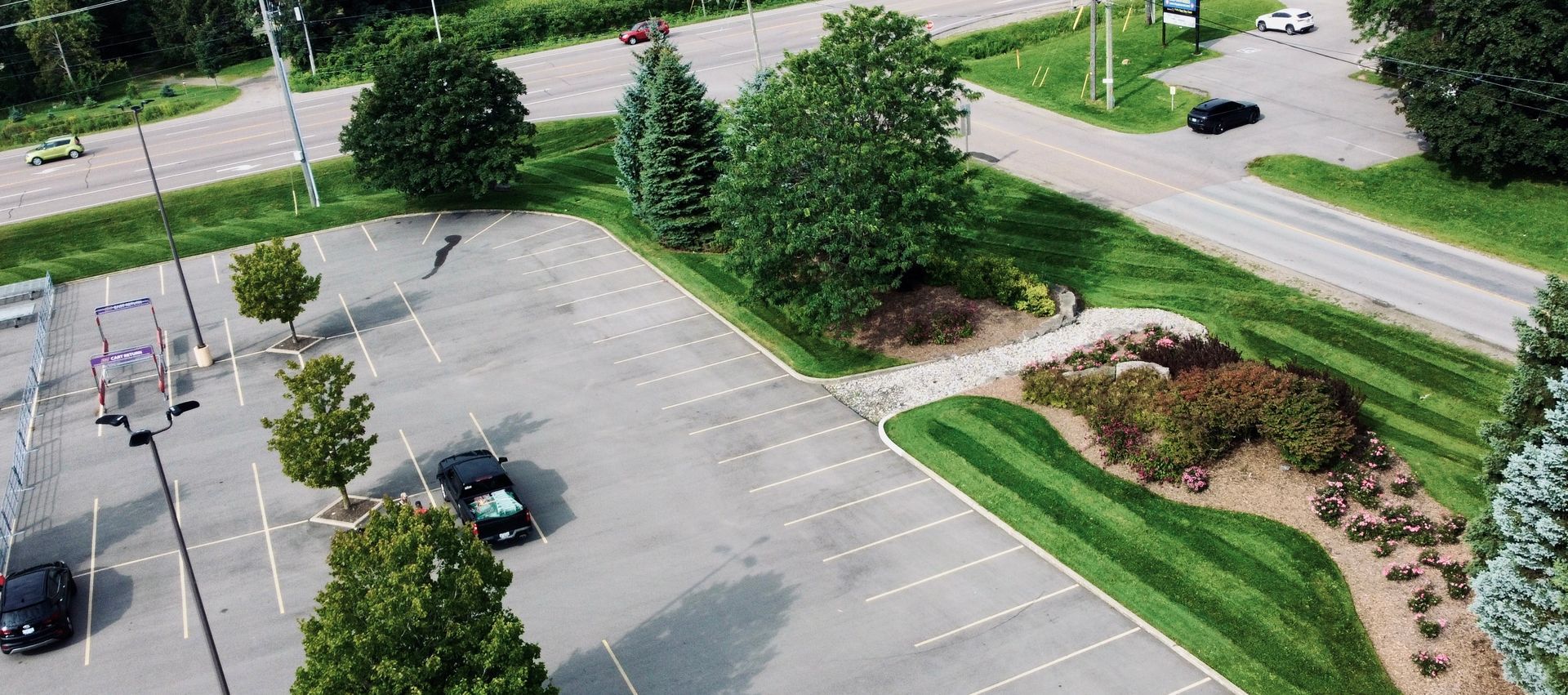 An aerial view of a parking lot with cars parked in it.