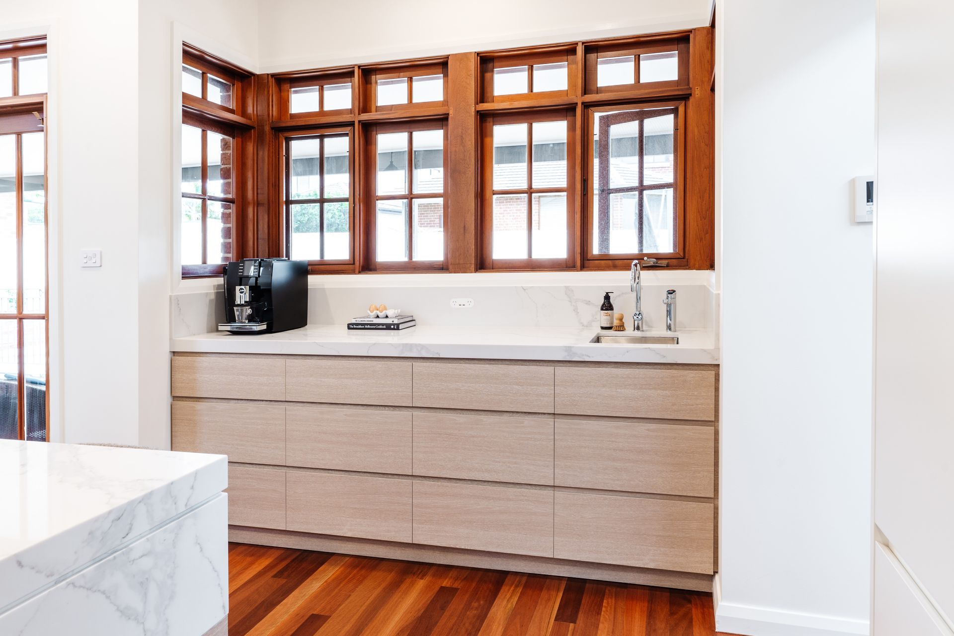 Bright Kitchen With Wood-framed Windows — PKJ Design in Unanderra, NSW