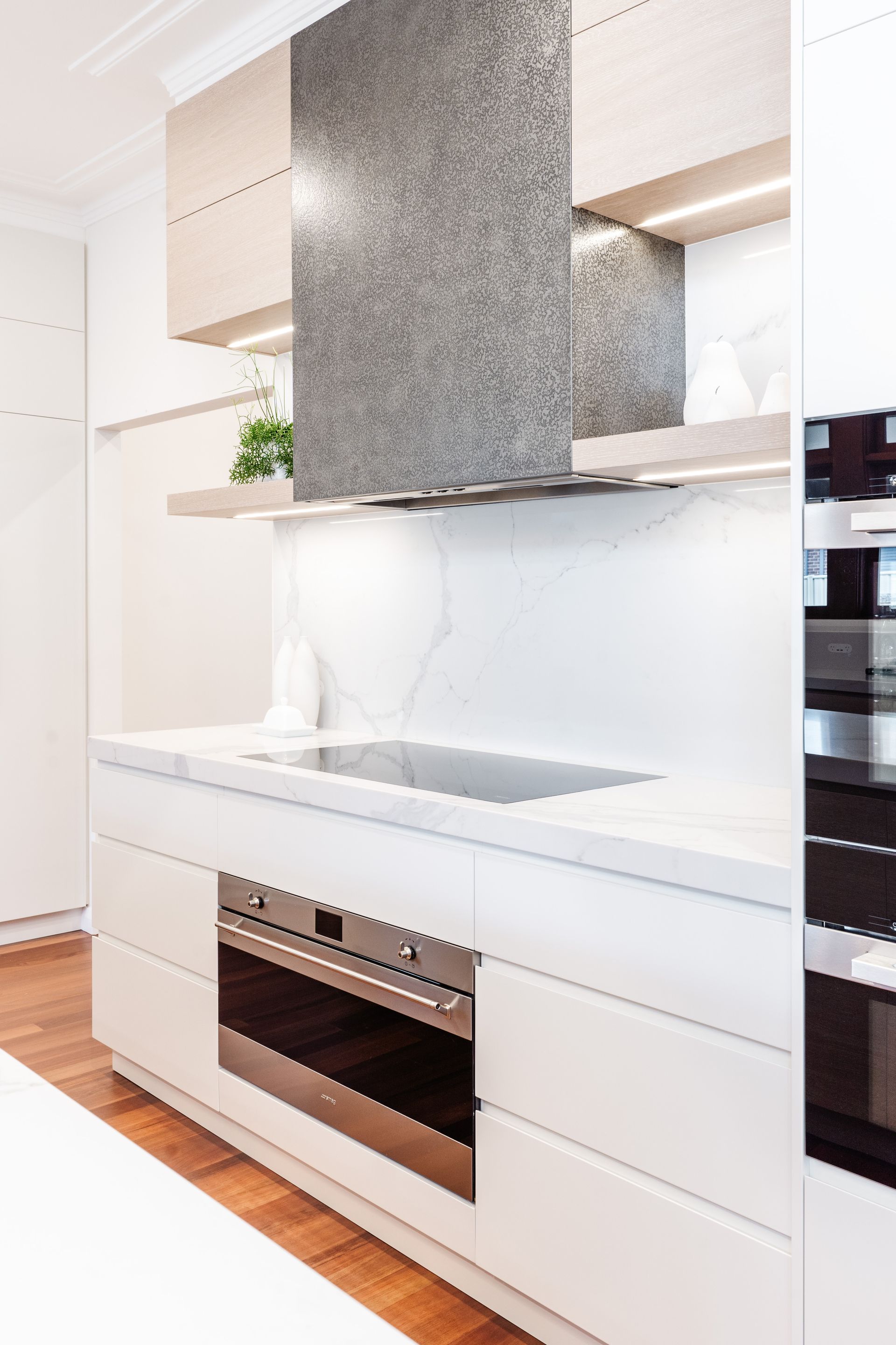 Modern White Kitchen With Stainless Steel Range Hood — PKJ Design in Unanderra, NSW
