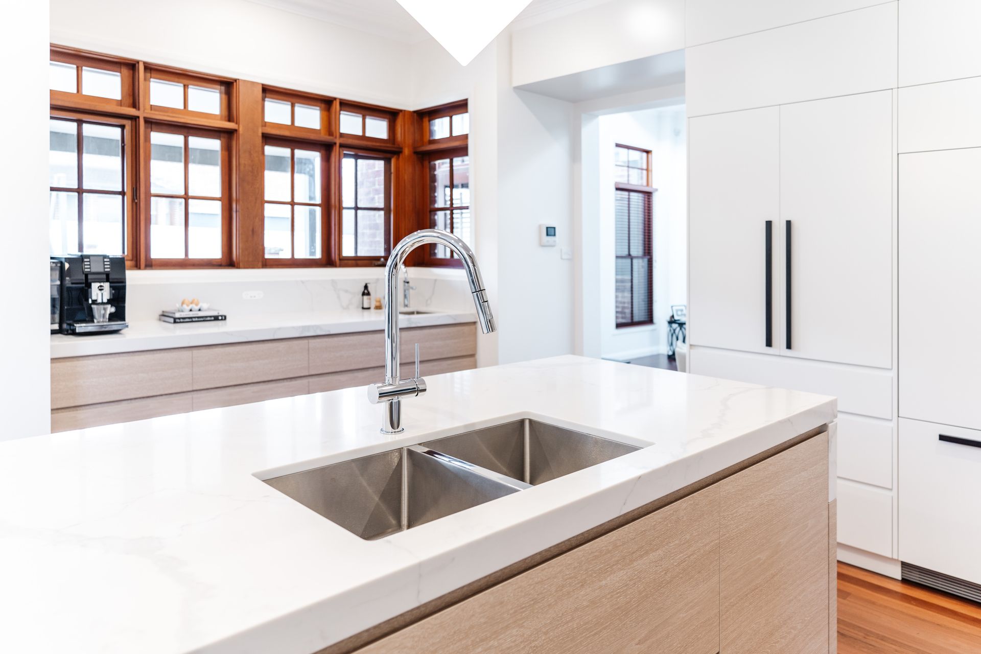 Modern Kitchen With a White Island, Double Sink, and Faucet — PKJ Design in Unanderra, NSW