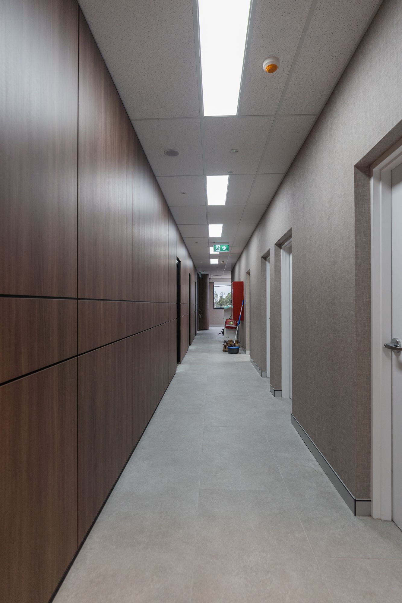 Long Office Hallway With Gray Carpet — PKJ Design in Unanderra, NSW