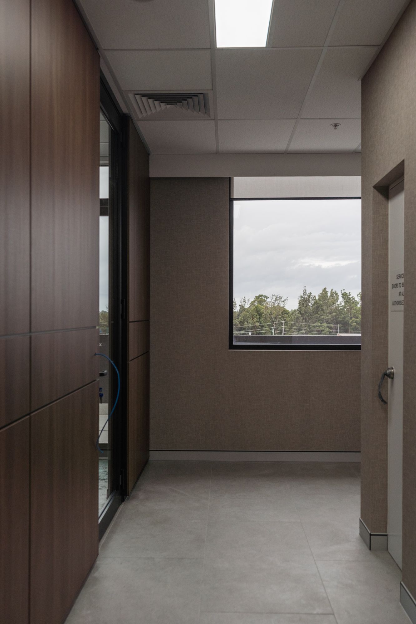 Narrow Office Hallway With Wood Paneling — PKJ Design in Unanderra, NSW