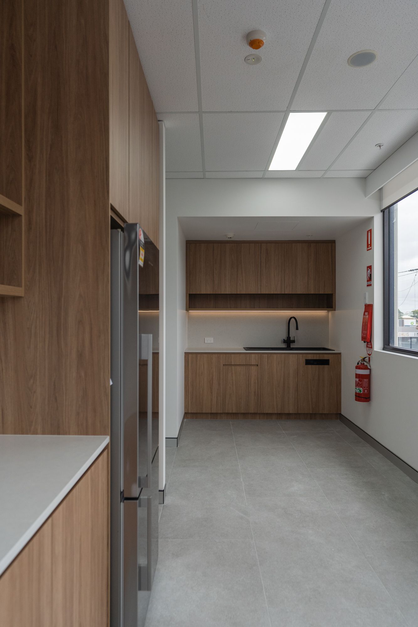 Modern Break Room With Wood Cabinets — PKJ Design in Unanderra, NSW