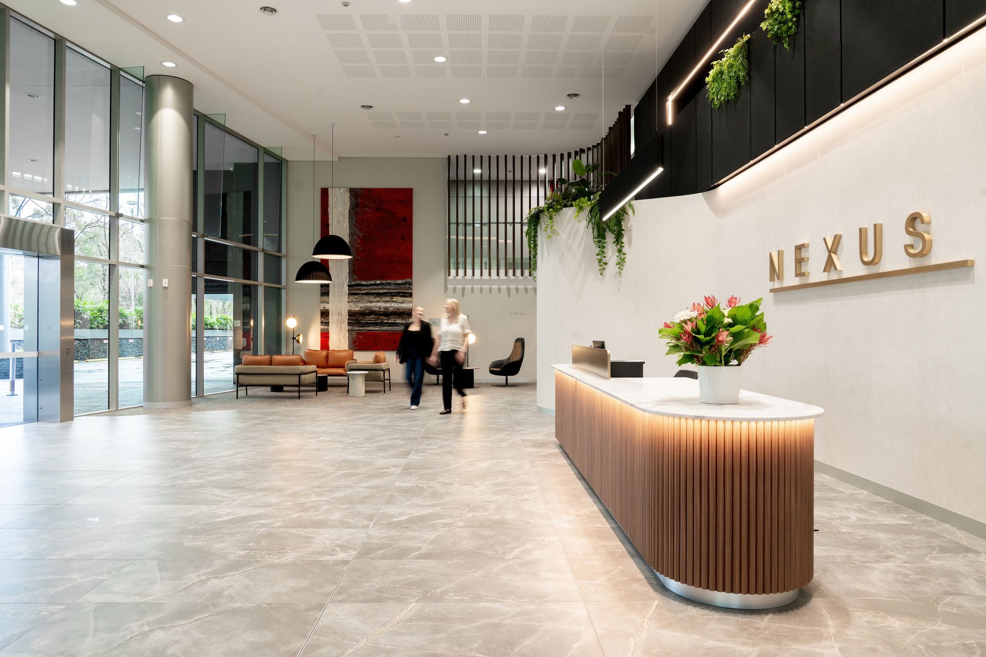 Modern Lobby With a Curved Wood Reception Desk — PKJ Design in Unanderra, NSW