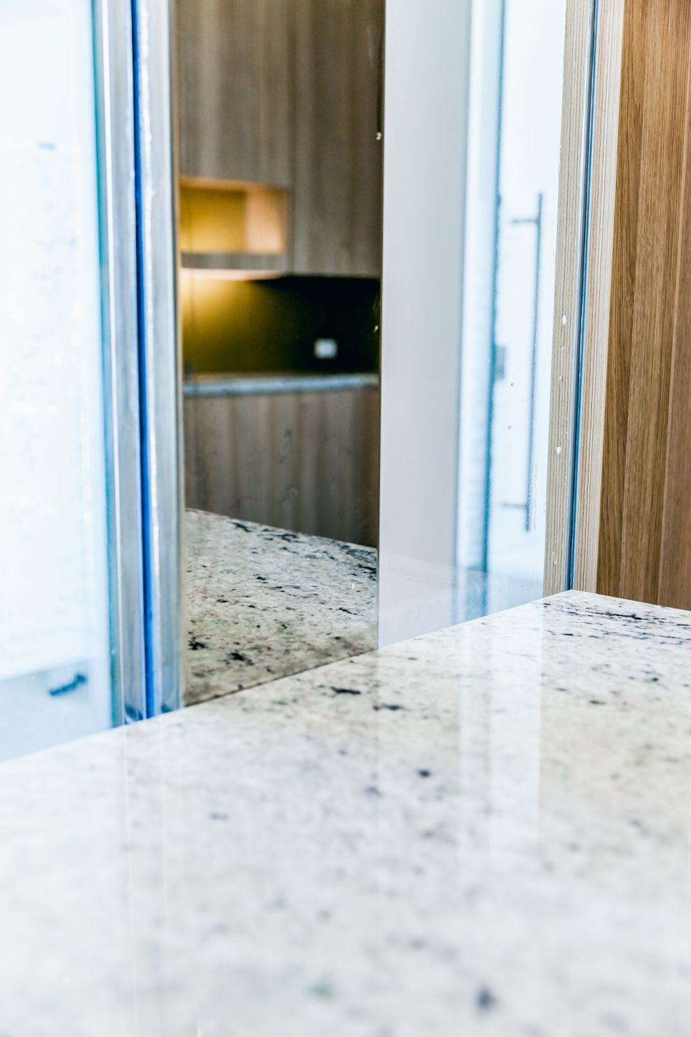 Bright Kitchen Countertop With a Mirror — PKJ Design in Unanderra, NSW
