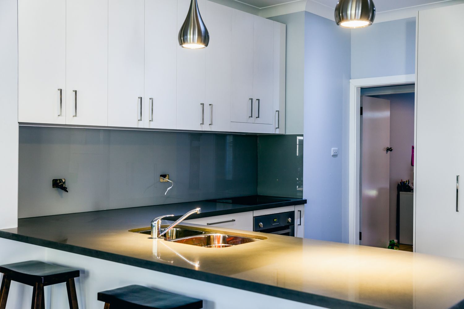 Modern White Kitchen With Island Sink — PKJ Design in Unanderra, NSW