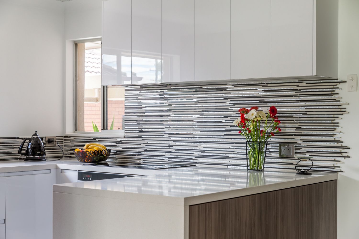 Modern White Kitchen With a Glossy Island — PKJ Design in Unanderra, NSW
