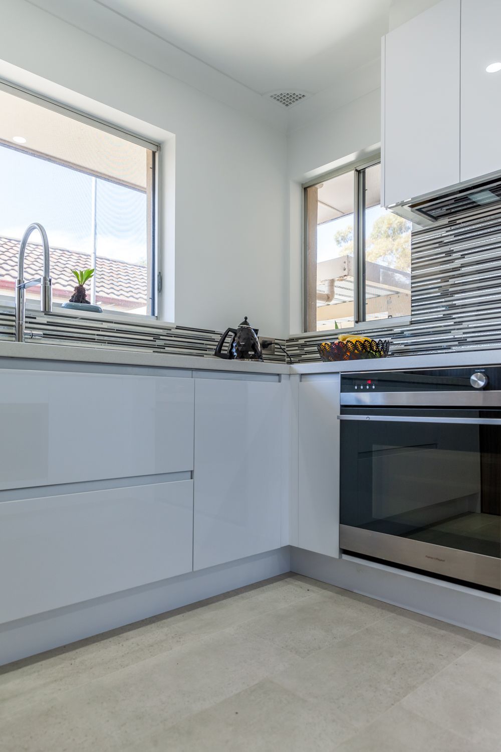 Bright Modern Kitchen Corner With White Cabinets — PKJ Design in Unanderra, NSW