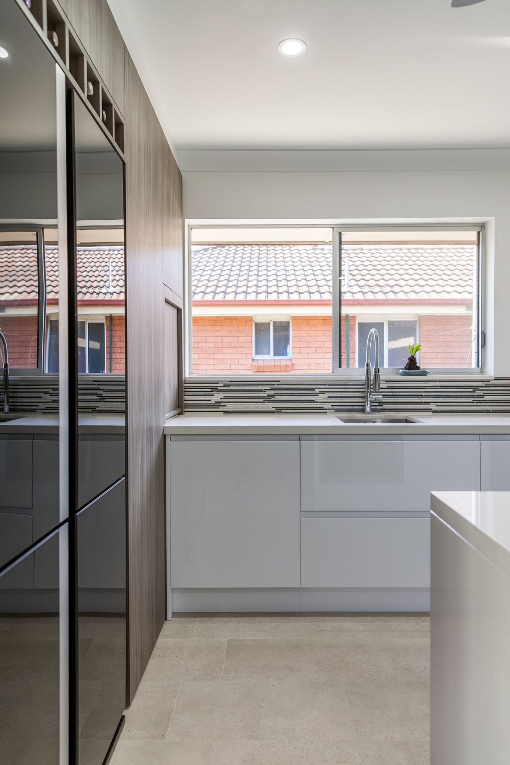 Modern Kitchen With Glossy Black Cabinets — PKJ Design in Unanderra, NSW