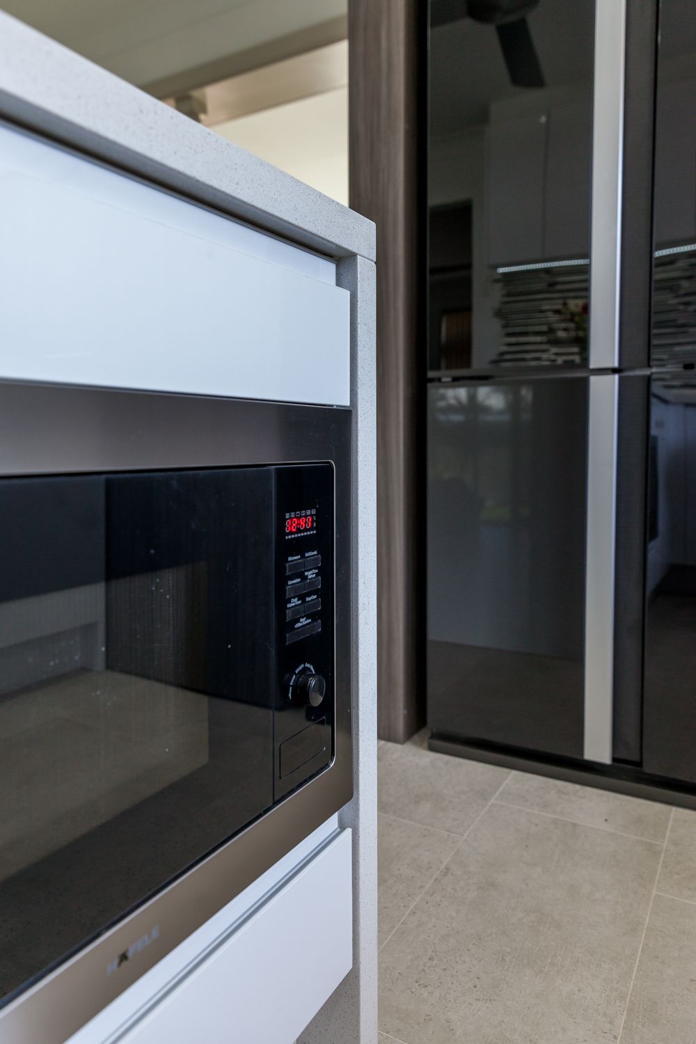 Built-in Microwave in a Kitchen Beside a Refrigerator — PKJ Design in Unanderra, NSW